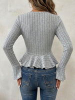 Long-sleeve, Ribbed V-neck Top With Buttons, A Cinched Waist, And A Ruffled Hem